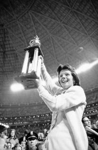 Billie Jean King holds trophy after beating Bobby Riggs
