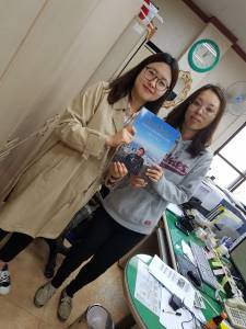 Two workers at Seonghwan Public Library holding A Seoul Miscellany