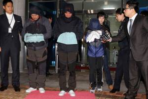 Cho Joon-Ki, Lee Joon-Seok and Park Han-Kyul with heads bowed before reporters