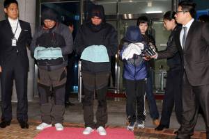 Cho Joon-Ki, Lee Joon-Seok and Park Han-Kyul with heads bowed before reporters