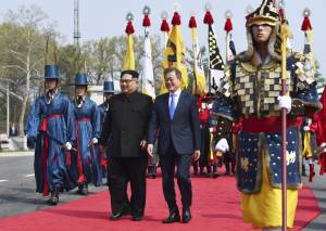 Kim Jong-Un and Moon Jae-In walk down red carpet at Panmunjeom