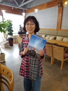 Proprietress of Cafe Lobby in Waegwan holding A Seoul Miscellany