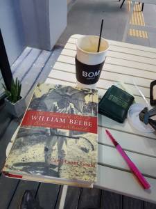 book on William Beebe with coffee and pen