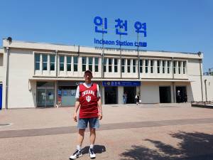 me in red Indiana University standing in front of Incheon Station
