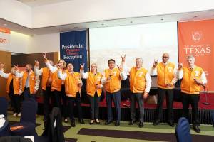 University of Texasofficials in orange and white jackets