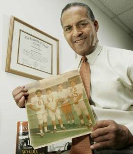 Julius Whittier poses with old newspaper clipping