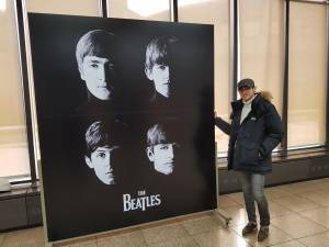 Tae-hoon Kim posing with poster of Beatles