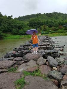 me holding umbrella on Nongari Bridge