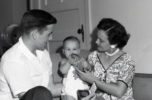 young Dee inspects dad's discuss and gold medal