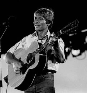 John Denver playing guitar
